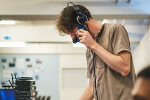 White man with headset performs sound check